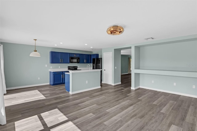 126 San Carlo Rd, Davenport, FL 33896 - kitchen with black appliances, blue cabinetry, light countertops, dark wood-style floors, and recessed lighting