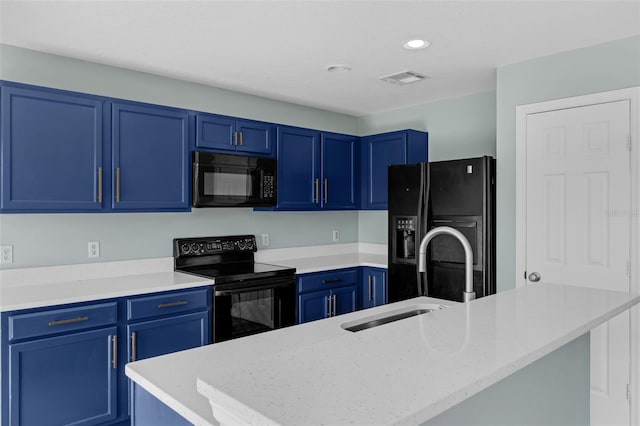126 San Carlo Rd, Davenport, FL 33896 - kitchen featuring black appliances, blue cabinetry, a sink, recessed lighting, and an island with sink
