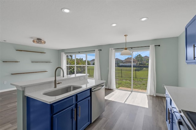 126 San Carlo Rd, Davenport, FL 33896 - kitchen with blue cabinetry, stainless steel appliances, a sink, dark wood-type flooring, and light countertops