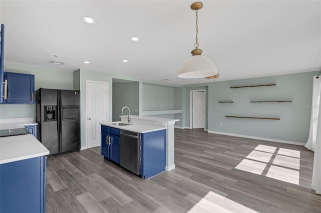 126 San Carlo Rd, Davenport, FL 33896 - kitchen featuring black fridge, stainless steel dishwasher, blue cabinets, a sink, and light countertops