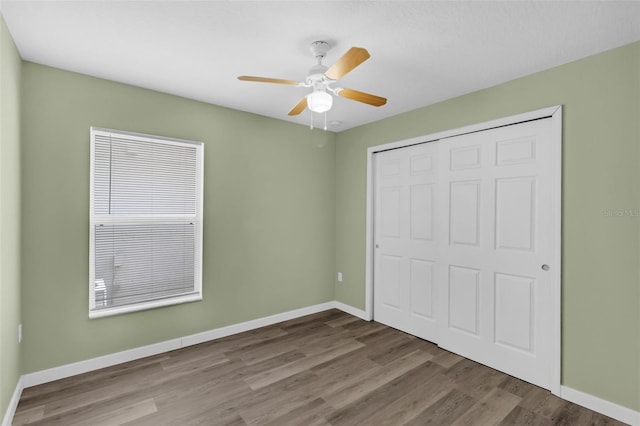 126 San Carlo Rd, Davenport, FL 33896 - unfurnished bedroom featuring wood finished floors, a closet, baseboards, and a ceiling fan