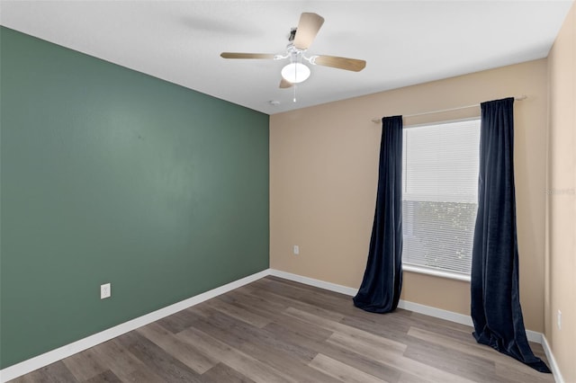 126 San Carlo Rd, Davenport, FL 33896 - unfurnished room with wood finished floors, a ceiling fan, and baseboards