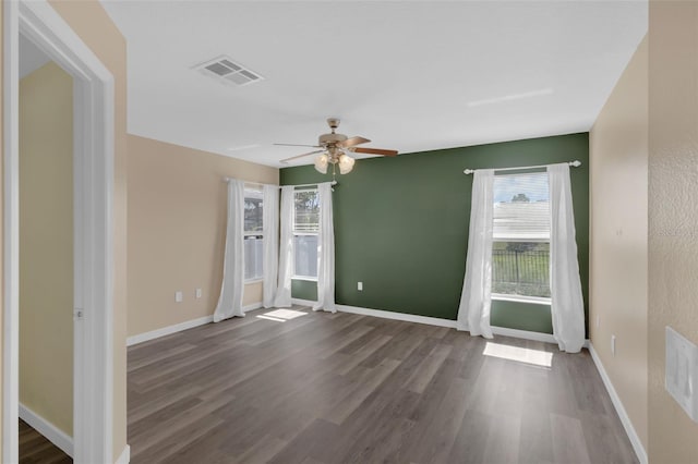 126 San Carlo Rd, Davenport, FL 33896 - spare room featuring a ceiling fan, dark wood-type flooring, and baseboards