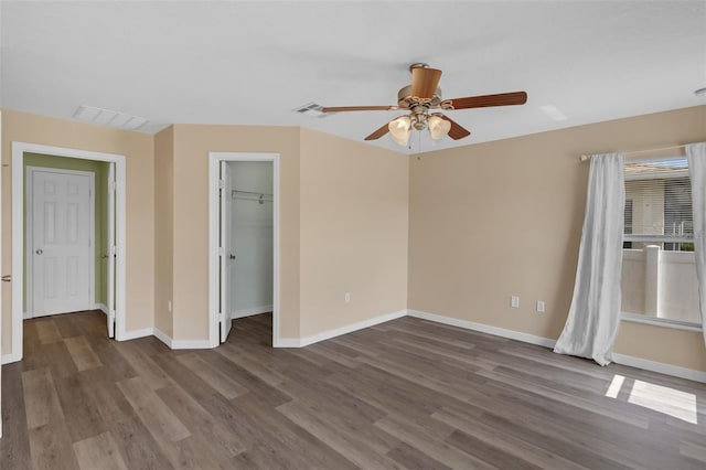 126 San Carlo Rd, Davenport, FL 33896 - unfurnished bedroom featuring baseboards, wood finished floors, a walk in closet, a ceiling fan, and a closet