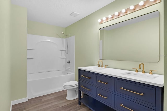 126 San Carlo Rd, Davenport, FL 33896 - full bath featuring double vanity, wood finished floors, toilet, tub / shower combination, and a textured ceiling