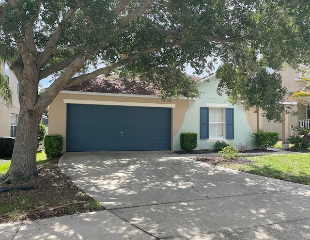 126 San Carlo Rd, Davenport, FL 33896 - view of property hidden behind natural elements with stucco siding, driveway, and an attached garage