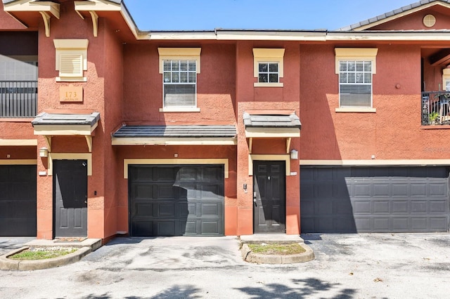 173 Villa Di Este Ter Unit 209, Lake Mary, FL 32746 - view of property featuring a garage and stucco siding