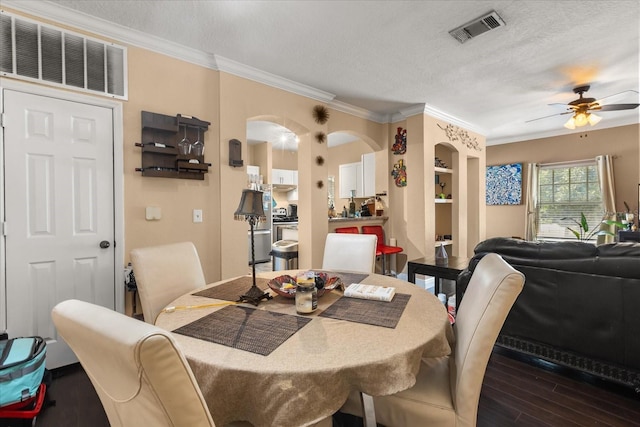 173 Villa Di Este Ter Unit 209, Lake Mary, FL 32746 - dining area with ceiling fan, arched walkways, wood finished floors, ornamental molding, and a textured ceiling