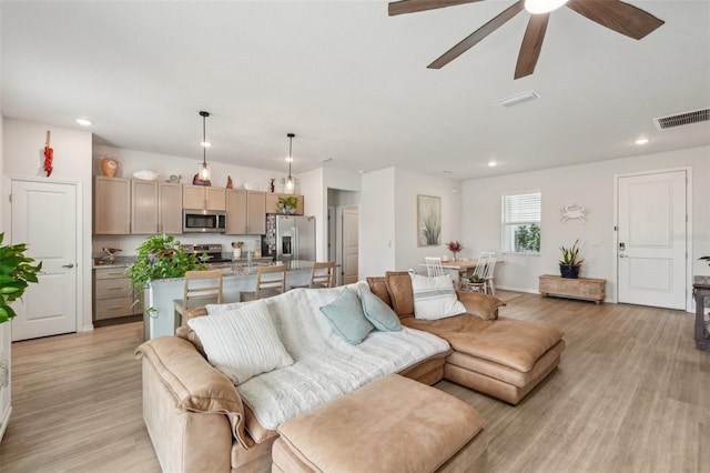 1909 Thomasville Ave SE, Palm Bay, FL 32909 - living area featuring light wood-type flooring, ceiling fan, and recessed lighting