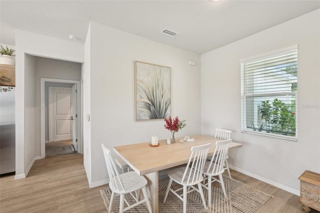 1909 Thomasville Ave SE, Palm Bay, FL 32909 - dining area featuring light wood-style flooring and baseboards