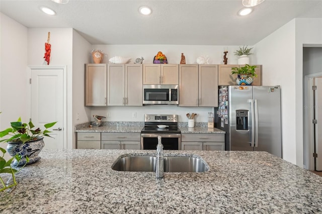 1909 Thomasville Ave SE, Palm Bay, FL 32909 - kitchen with stainless steel appliances, a sink, light stone countertops, and recessed lighting
