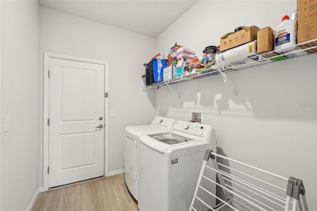 1909 Thomasville Ave SE, Palm Bay, FL 32909 - washroom featuring washing machine and clothes dryer, light wood finished floors, and baseboards