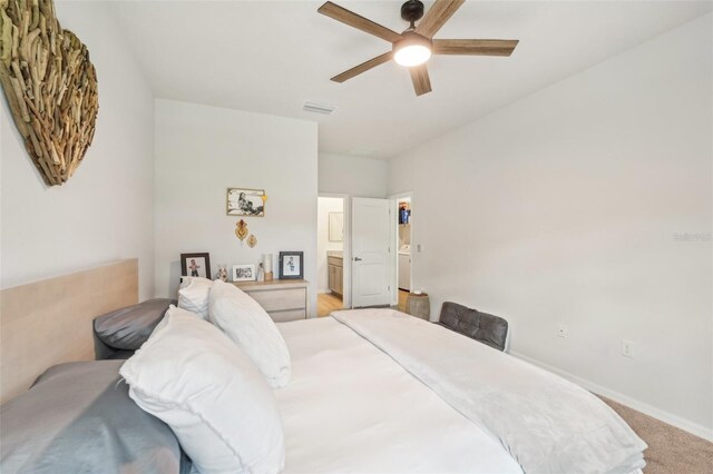 1909 Thomasville Ave SE, Palm Bay, FL 32909 - bedroom featuring baseboards, light colored carpet, ensuite bathroom, and ceiling fan