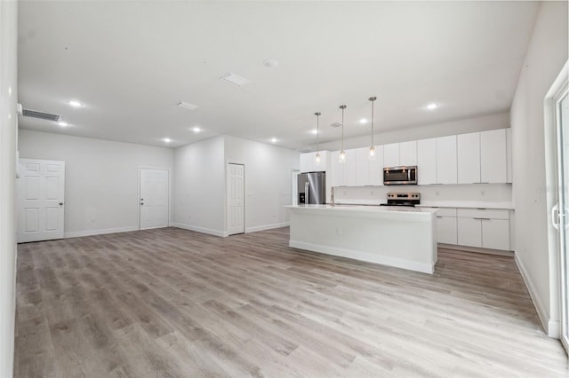 8944 N Pitcairn Way, Citrus Springs, FL 34434 - kitchen with stainless steel appliances, recessed lighting, light wood-style flooring, white cabinetry, and baseboards