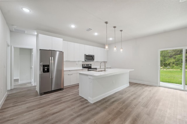 8944 N Pitcairn Way, Citrus Springs, FL 34434 - kitchen featuring appliances with stainless steel finishes, a sink, light wood finished floors, white cabinets, and recessed lighting