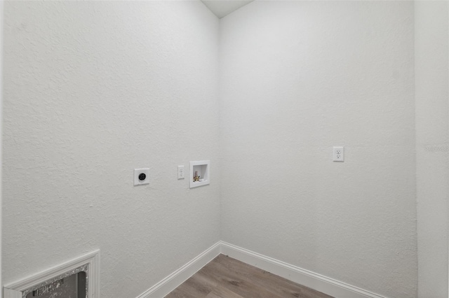 8944 N Pitcairn Way, Citrus Springs, FL 34434 - laundry area featuring electric dryer hookup, wood finished floors, hookup for a washing machine, and baseboards