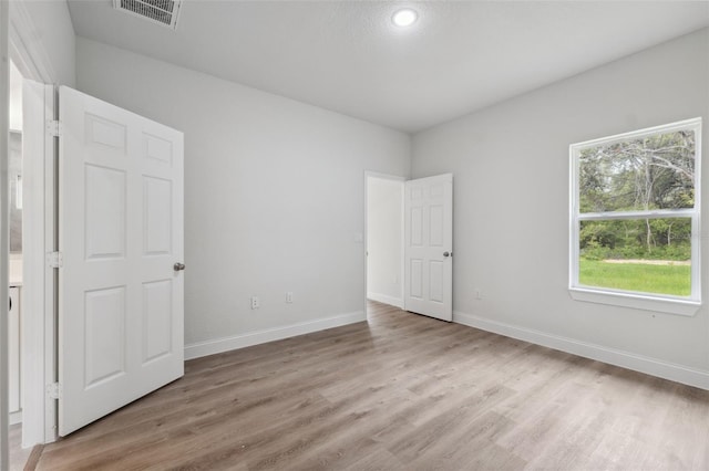 8944 N Pitcairn Way, Citrus Springs, FL 34434 - unfurnished bedroom with light wood-style floors, baseboards, and recessed lighting