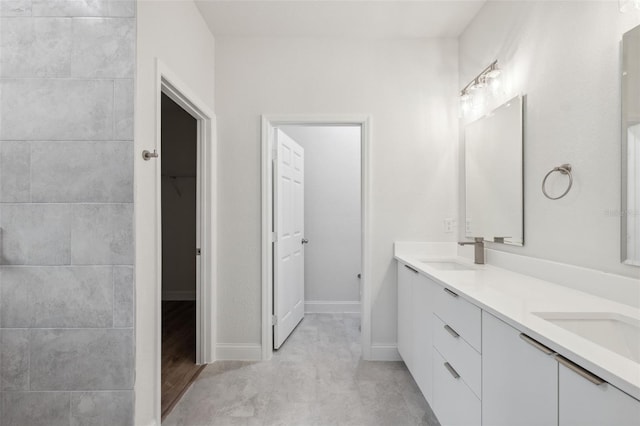 8944 N Pitcairn Way, Citrus Springs, FL 34434 - bathroom featuring double vanity and baseboards