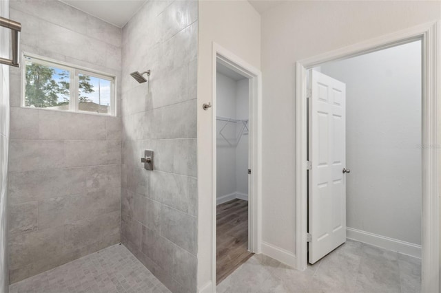 8944 N Pitcairn Way, Citrus Springs, FL 34434 - full bath with tiled shower, a spacious closet, baseboards, and tile patterned flooring