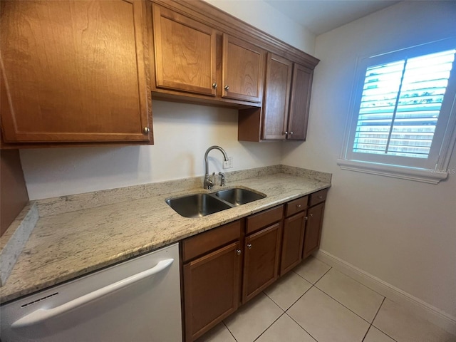 2426 Windward Way, Winter Park, FL 32792 - kitchen featuring dishwasher, a sink, light tile patterned flooring, baseboards, and light stone countertops