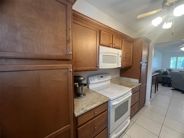 2426 Windward Way, Winter Park, FL 32792 - kitchen featuring white appliances, a ceiling fan, light tile patterned floors, brown cabinets, and light stone counters