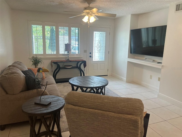 2426 Windward Way, Winter Park, FL 32792 - living area featuring light tile patterned floors, a textured ceiling, a ceiling fan, and baseboards