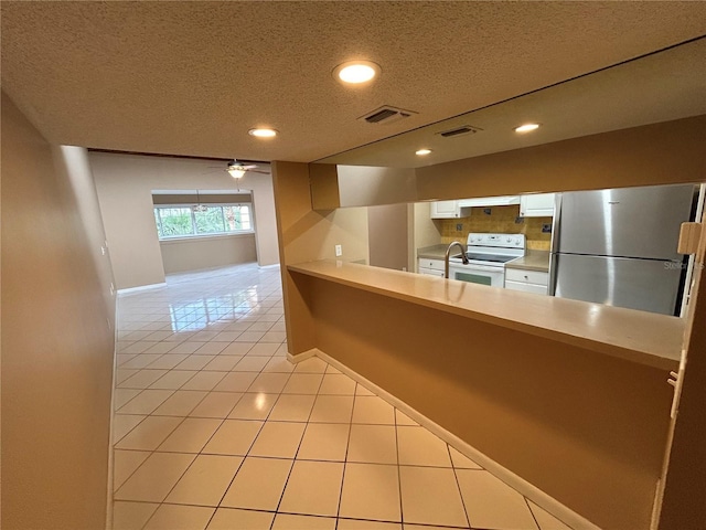 510 Cranes Way Unit 302, Altamonte Springs, FL 32701 - kitchen featuring freestanding refrigerator, white electric stove, white cabinetry, baseboards, and a textured ceiling