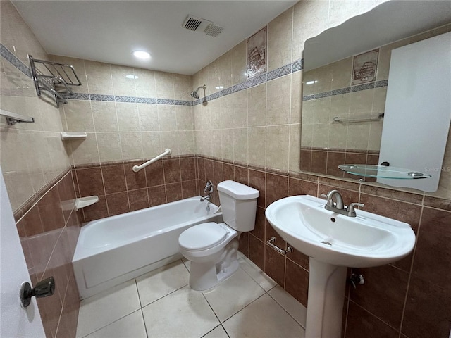 510 Cranes Way Unit 302, Altamonte Springs, FL 32701 - bathroom with tile walls, shower / bathtub combination, toilet, tile patterned floors, and a sink