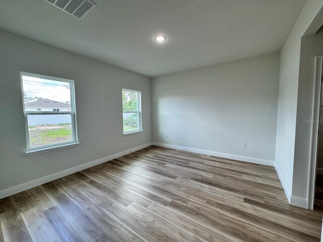 16463 SW 55th Court Rd, Ocala, FL 34473 - unfurnished room featuring baseboards, wood finished floors, and recessed lighting