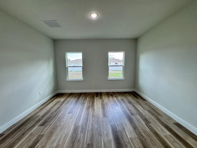 16463 SW 55th Court Rd, Ocala, FL 34473 - spare room with dark wood-style floors, baseboards, and recessed lighting