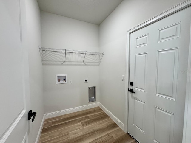 16463 SW 55th Court Rd, Ocala, FL 34473 - laundry room with electric dryer hookup, wood finished floors, hookup for a washing machine, and baseboards