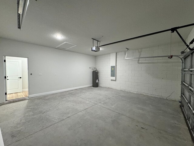 16463 SW 55th Court Rd, Ocala, FL 34473 - garage with a garage door opener, electric water heater, electric panel, and concrete block wall