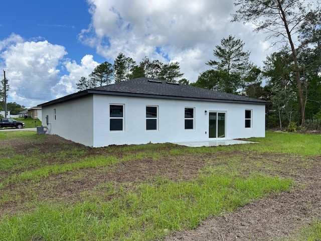 16463 SW 55th Court Rd, Ocala, FL 34473 - back of property with stucco siding, roof with shingles, and central AC