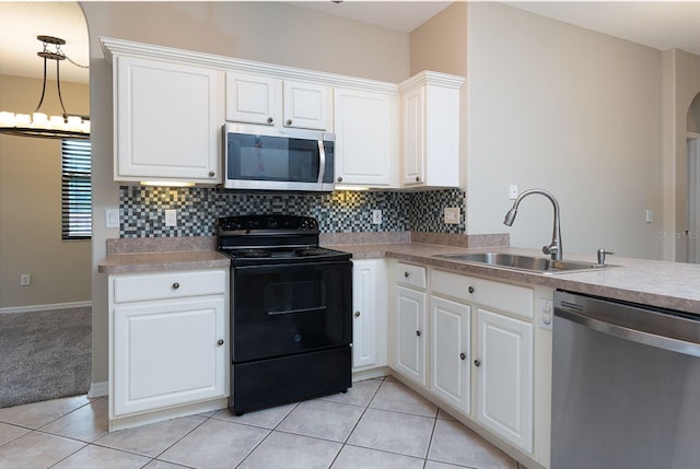1322 Reagans Reserve Blvd, Apopka, FL 32712 - kitchen with stainless steel appliances, arched walkways, backsplash, and light countertops