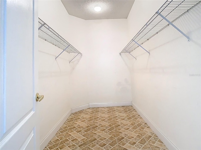 6843 Cherry Grove Cir, Orlando, FL 32809 - walk in closet featuring stone finish flooring
