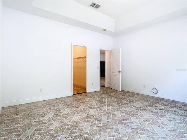 6843 Cherry Grove Cir, Orlando, FL 32809 - unfurnished bedroom with baseboards, a walk in closet, a closet, and a high ceiling