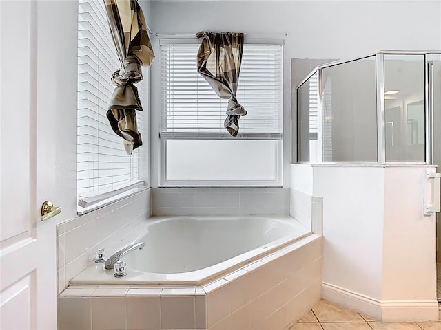 6843 Cherry Grove Cir, Orlando, FL 32809 - bathroom with a bath, a shower stall, and tile patterned floors