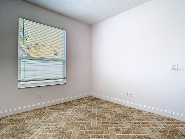 6843 Cherry Grove Cir, Orlando, FL 32809 - empty room with baseboards and a textured ceiling