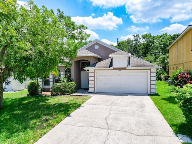 6843 Cherry Grove Cir, Orlando, FL 32809 - view of front facade with a front yard, roof with shingles, concrete driveway, and an attached garage