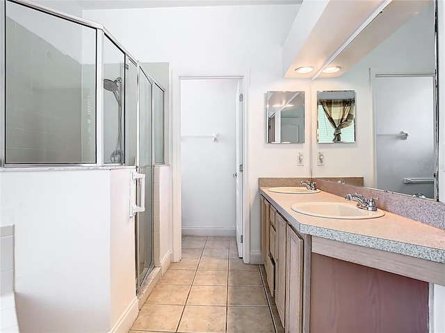 6843 Cherry Grove Cir, Orlando, FL 32809 - bathroom featuring a stall shower, double vanity, tile patterned floors, and baseboards