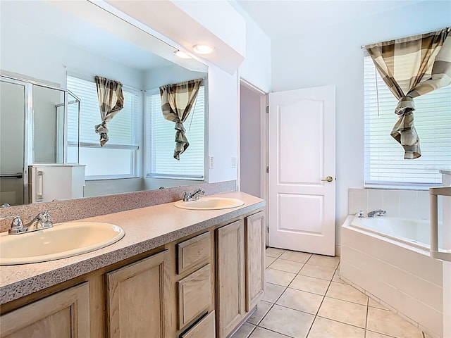 6843 Cherry Grove Cir, Orlando, FL 32809 - bathroom featuring a garden tub, tile patterned floors, double vanity, and plenty of natural light