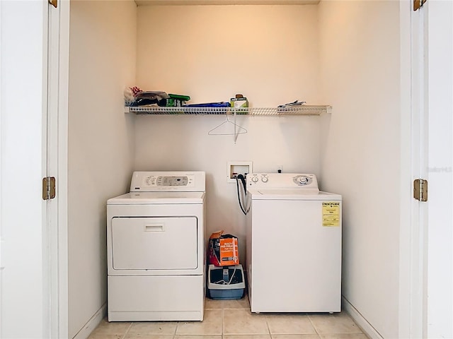 6843 Cherry Grove Cir, Orlando, FL 32809 - washroom featuring separate washer and dryer, light tile patterned floors, and baseboards