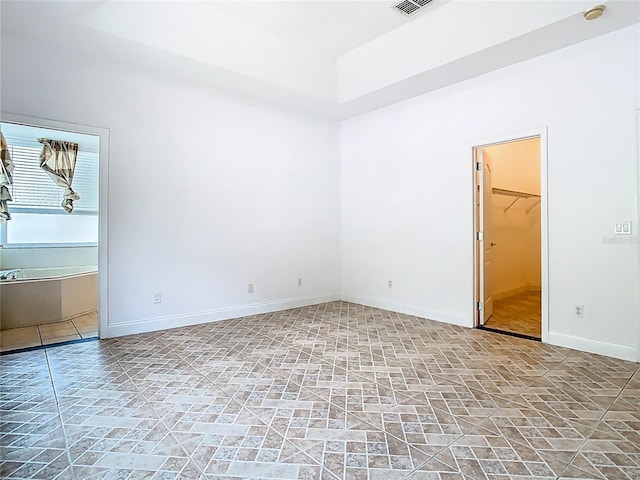 6843 Cherry Grove Cir, Orlando, FL 32809 - empty room featuring stone finish flooring, baseboards, and a smoke detector