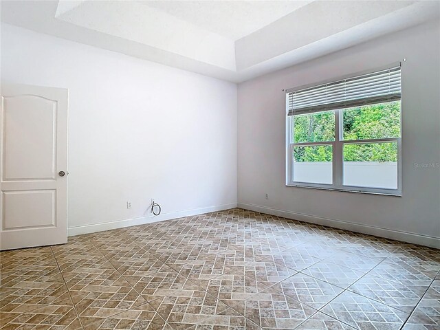 6843 Cherry Grove Cir, Orlando, FL 32809 - unfurnished room featuring baseboards and a raised ceiling
