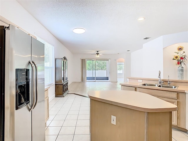 6843 Cherry Grove Cir, Orlando, FL 32809 - kitchen featuring stainless steel fridge with ice dispenser, a sink, arched walkways, ceiling fan, and light tile patterned floors