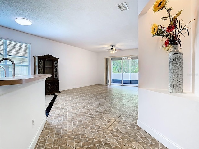 6843 Cherry Grove Cir, Orlando, FL 32809 - unfurnished living room with ceiling fan, baseboards, and a sink