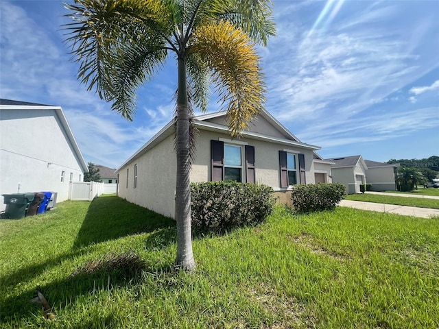 2983 Boating Blvd, Kissimmee, FL 34746 - view of home's exterior with stucco siding and a garage