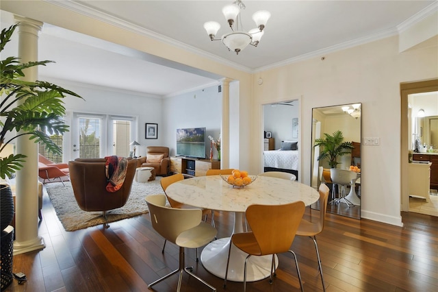 2305 Edgewater Dr Unit 1613, Orlando, FL 32804 - dining room featuring ornate columns, dark wood-style flooring, ornamental molding, a chandelier, and baseboards