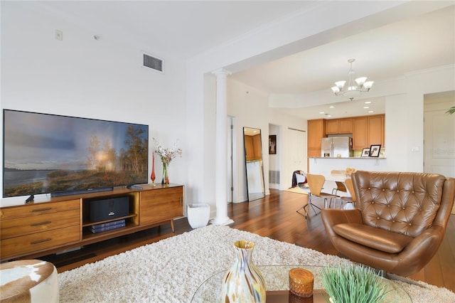 2305 Edgewater Dr Unit 1613, Orlando, FL 32804 - living room featuring a chandelier, decorative columns, wood finished floors, and ornamental molding
