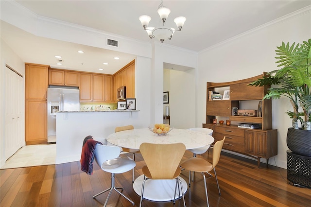 2305 Edgewater Dr Unit 1613, Orlando, FL 32804 - dining area featuring wood-type flooring, crown molding, and a chandelier